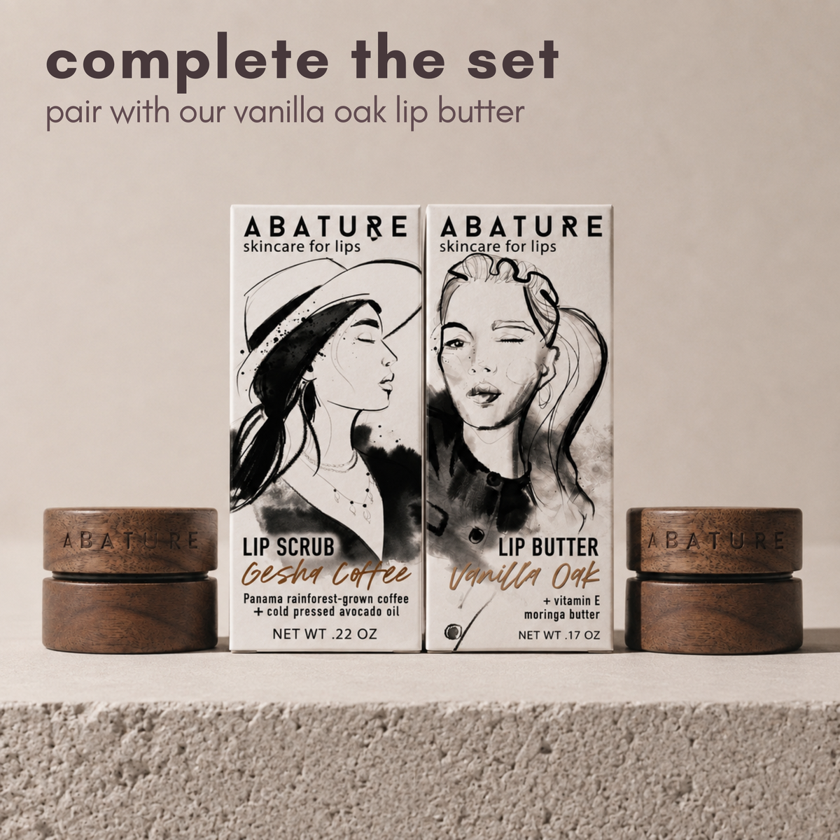 Two ABATURE skincare products displayed on a textured surface: a Lip Scrub Gesha Coffee and a Lip Butter Vanilla Oak, with two matching wooden jars on each side. Text at the top reads 'complete the set. Pair with our vanilla oak lip butter'.